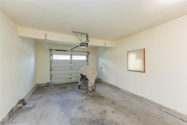 1730 W 20th St, Lorain, OH 44052 - garage featuring a garage door opener and baseboards