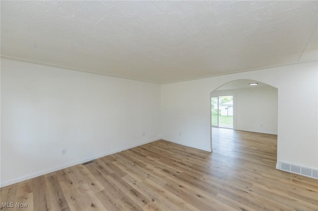 1730 W 20th St, Lorain, OH 44052 - unfurnished room with arched walkways and light wood finished floors