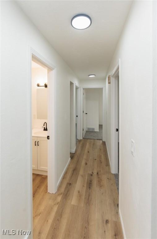 1730 W 20th St, Lorain, OH 44052 - corridor featuring light wood finished floors