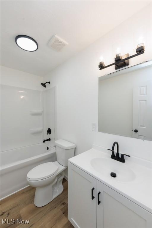 1730 W 20th St, Lorain, OH 44052 - full bath featuring vanity, wood finished floors, and bathtub / shower combination