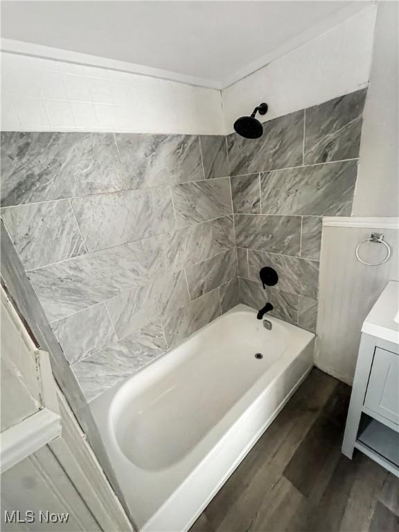 4017 E 54th St, Newburgh Heights, OH 44105 - bathroom featuring wood finished floors, bathing tub / shower combination, and vanity
