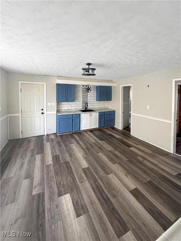 4017 E 54th St, Newburgh Heights, OH 44105 - unfurnished living room with a textured ceiling and dark wood-style floors