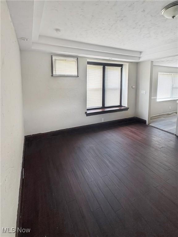 4017 E 54th St, Newburgh Heights, OH 44105 - empty room with dark wood-style flooring and a textured ceiling