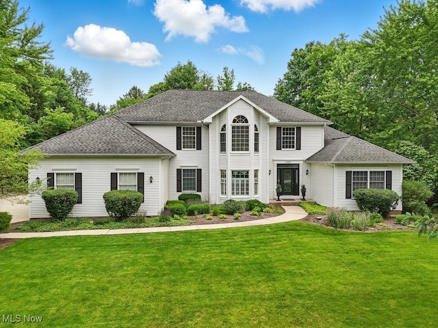1497 Hunting Hollow Dr, Hudson, OH 44236 - colonial-style house featuring a front lawn and roof with shingles