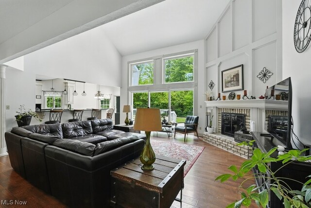 1497 Hunting Hollow Dr, Hudson, OH 44236 - living room with high vaulted ceiling, dark wood-style flooring, and a fireplace