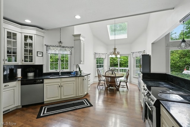 1497 Hunting Hollow Dr, Hudson, OH 44236 - kitchen with stainless steel appliances, a skylight, dark countertops, glass insert cabinets, and recessed lighting
