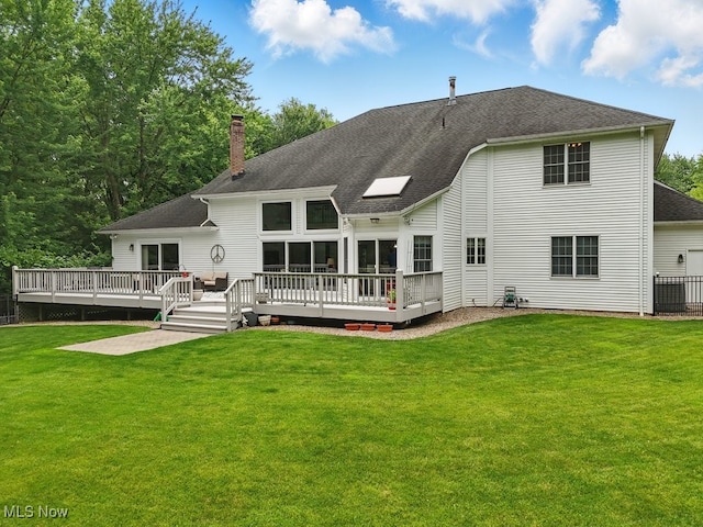 1497 Hunting Hollow Dr, Hudson, OH 44236 - back of property with a chimney, a yard, roof with shingles, and a deck