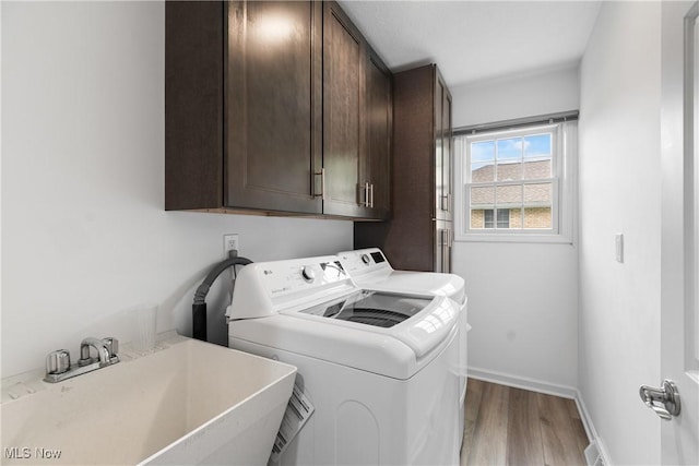 4270 Sir Robert Ave, North Royalton, OH 44133 - laundry room with cabinet space, washer and dryer, and wood finished floors