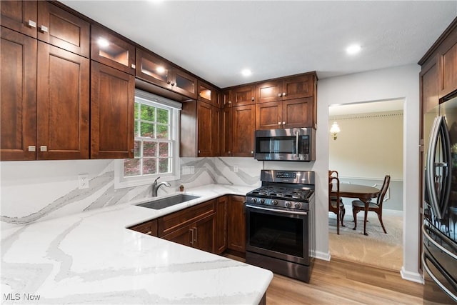 4270 Sir Robert Ave, North Royalton, OH 44133 - kitchen featuring appliances with stainless steel finishes, light stone counters, light wood finished floors, glass insert cabinets, and recessed lighting