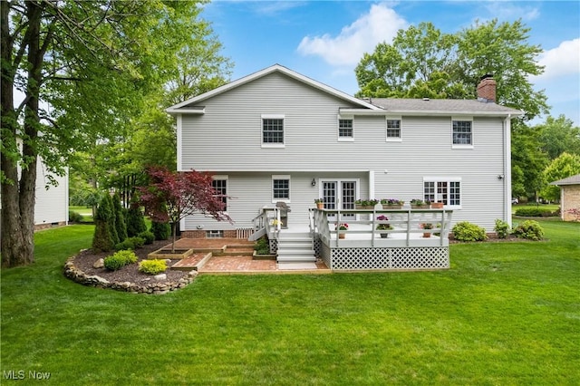4270 Sir Robert Ave, North Royalton, OH 44133 - rear view of property with a chimney, a lawn, and a deck