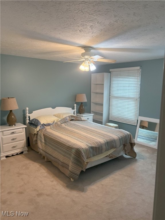 3611 Mark Dr, Broadview Heights, OH 44147 - bedroom featuring light colored carpet, a textured ceiling, and a ceiling fan