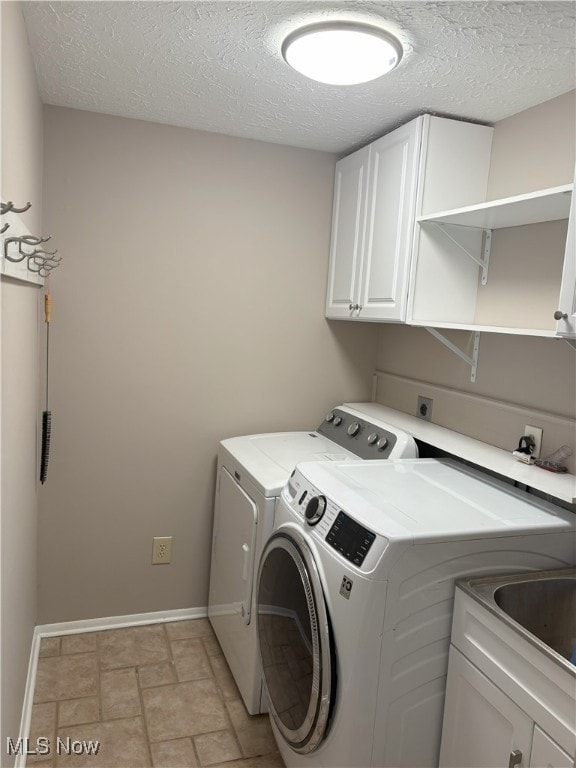 3611 Mark Dr, Broadview Heights, OH 44147 - laundry area featuring separate washer and dryer, cabinet space, a textured ceiling, and light stone finish flooring