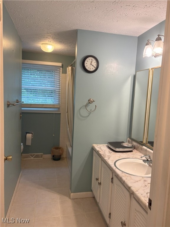 3611 Mark Dr, Broadview Heights, OH 44147 - full bathroom featuring vanity, tile patterned flooring, a textured ceiling, and shower / bath combination with curtain