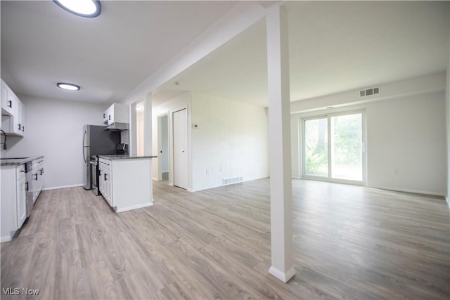 8507 Akins Rd Unit C-2, North Royalton, OH 44133 - kitchen featuring open floor plan, light wood-type flooring, stove, and white cabinetry