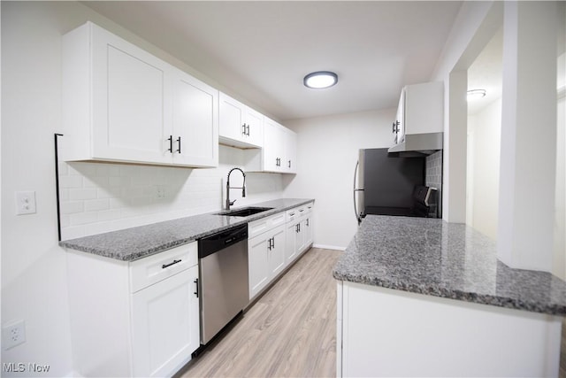 8507 Akins Rd Unit C-2, North Royalton, OH 44133 - kitchen with dishwasher, stove, under cabinet range hood, light wood-style floors, and decorative backsplash