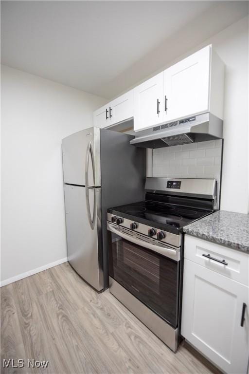 8507 Akins Rd Unit C-2, North Royalton, OH 44133 - kitchen with appliances with stainless steel finishes, under cabinet range hood, light wood-style floors, light stone counters, and white cabinets
