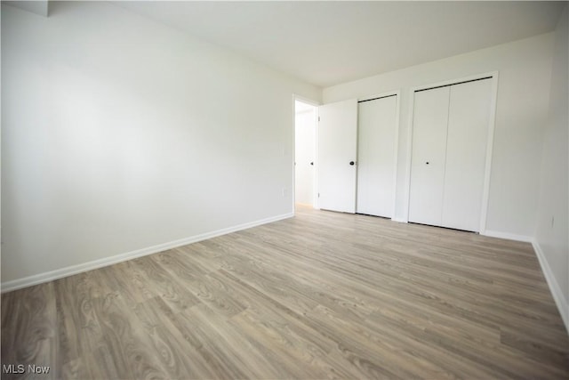 8507 Akins Rd Unit C-2, North Royalton, OH 44133 - unfurnished bedroom featuring two closets and wood finished floors