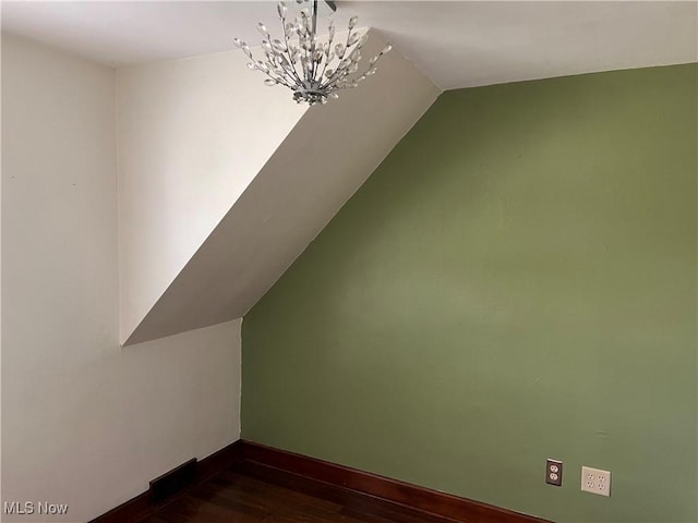 913 Home Cir, Salem, OH 44460 - additional living space with a chandelier, vaulted ceiling, and dark wood-style floors