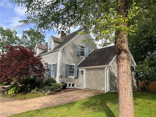 913 Home Cir, Salem, OH 44460 - view of front facade featuring concrete driveway, a chimney, a garage, and a shingled roof