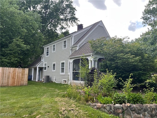913 Home Cir, Salem, OH 44460 - back of property featuring a chimney, a sunroom, and a shingled roof