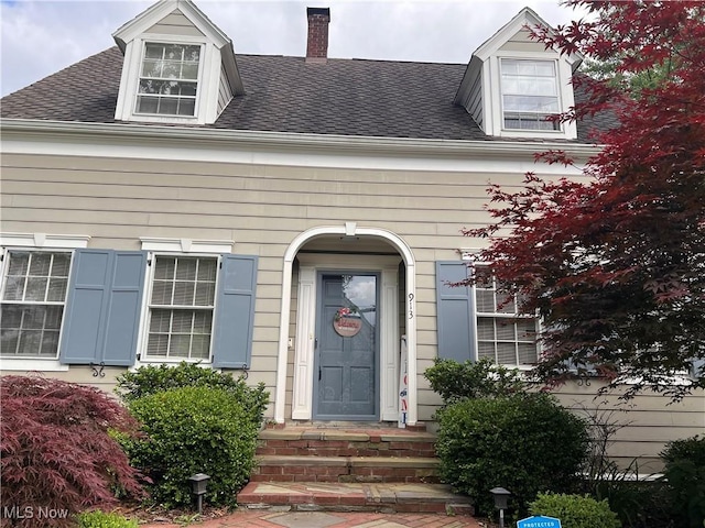 913 Home Cir, Salem, OH 44460 - doorway to property featuring a shingled roof and a chimney