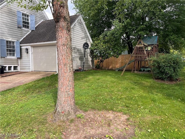 913 Home Cir, Salem, OH 44460 - view of yard with concrete driveway, a playground, and a garage