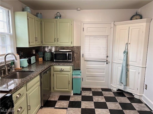 913 Home Cir, Salem, OH 44460 - kitchen featuring green cabinetry, stainless steel appliances, dark flooring, tasteful backsplash, and dark stone countertops