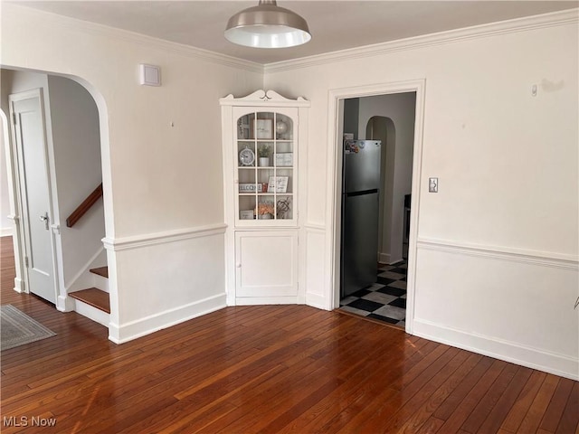 913 Home Cir, Salem, OH 44460 - unfurnished dining area with arched walkways, hardwood / wood-style floors, crown molding, and stairway
