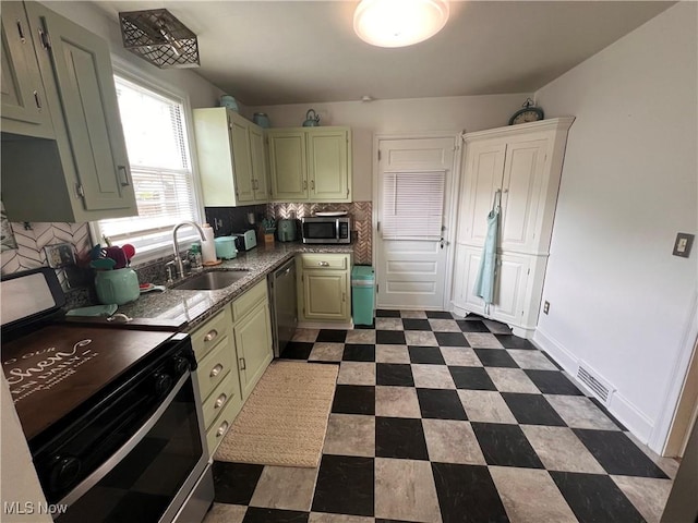 913 Home Cir, Salem, OH 44460 - kitchen with appliances with stainless steel finishes, tasteful backsplash, dark floors, and green cabinets