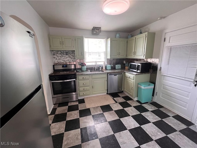 913 Home Cir, Salem, OH 44460 - kitchen with stainless steel appliances, tasteful backsplash, and green cabinetry