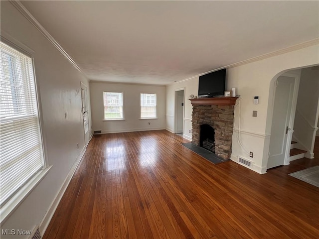 913 Home Cir, Salem, OH 44460 - unfurnished living room with wood-type flooring, a fireplace, arched walkways, crown molding, and stairway
