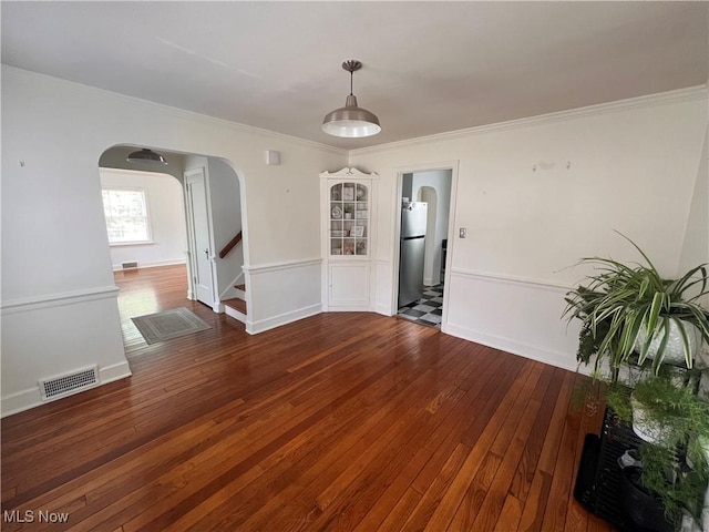 913 Home Cir, Salem, OH 44460 - unfurnished room with arched walkways, wood-type flooring, crown molding, and stairs