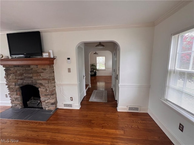 913 Home Cir, Salem, OH 44460 - unfurnished living room featuring wood finished floors, a fireplace, arched walkways, and crown molding