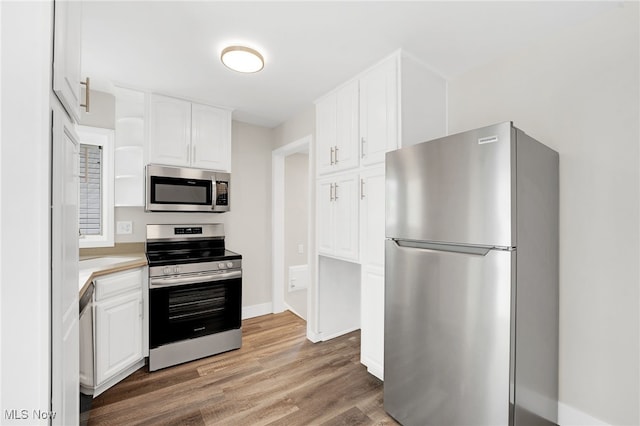 452 E 329th St, Willowick, OH 44095 - kitchen with appliances with stainless steel finishes, white cabinetry, light wood-style floors, light countertops, and open shelves
