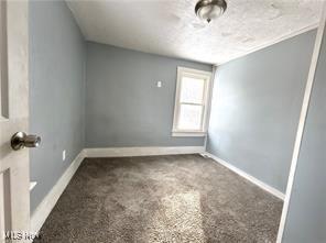 1222 Florida Ave, Akron, OH 44314 - carpeted spare room with baseboards