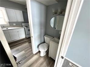1222 Florida Ave, Akron, OH 44314 - bathroom with wood finished floors, vanity, and washer / clothes dryer