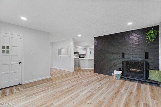 164 Goodview Ave, Akron, OH 44305 - unfurnished living room featuring light wood-type flooring, a fireplace, and recessed lighting