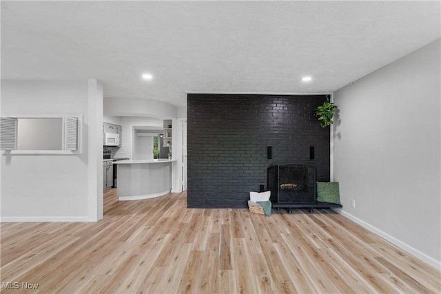 164 Goodview Ave, Akron, OH 44305 - unfurnished living room with light wood finished floors, a brick fireplace, and recessed lighting