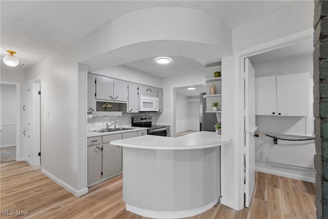 164 Goodview Ave, Akron, OH 44305 - kitchen with stainless steel electric range, white microwave, light countertops, and light wood-style floors