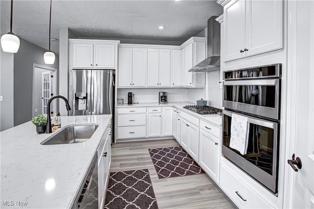 23797 St Andrews Dr, Columbia Station, OH 44028 - kitchen featuring stainless steel appliances, wall chimney range hood, white cabinetry, light stone counters, and recessed lighting