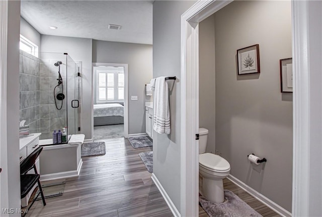 23797 St Andrews Dr, Columbia Station, OH 44028 - ensuite bathroom with a stall shower, healthy amount of natural light, vanity, and wood finished floors