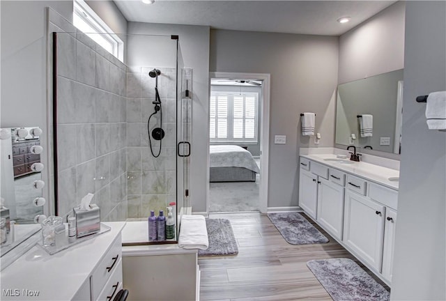 23797 St Andrews Dr, Columbia Station, OH 44028 - bathroom with healthy amount of natural light, vanity, tiled shower, wood finished floors, and recessed lighting