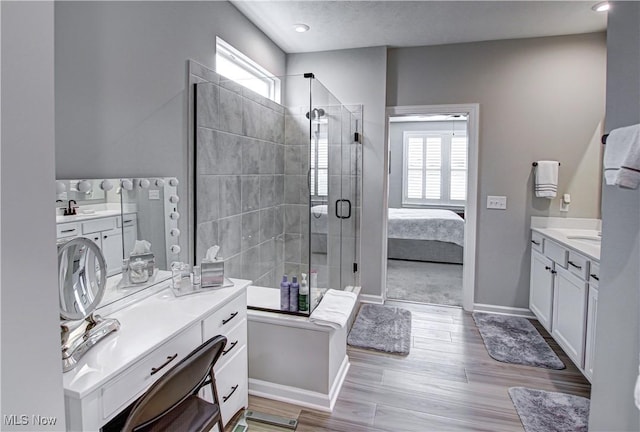 23797 St Andrews Dr, Columbia Station, OH 44028 - ensuite bathroom with two vanities, a shower stall, and wood finished floors