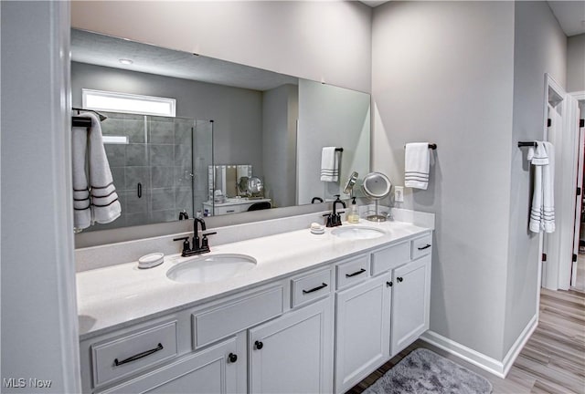 23797 St Andrews Dr, Columbia Station, OH 44028 - bathroom featuring double vanity, a shower stall, and wood finished floors