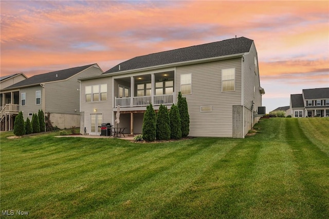 8488 Raya Ln, Streetsboro, OH 44241 - back of house featuring a patio area, a lawn, and a sunroom