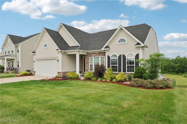 8488 Raya Ln, Streetsboro, OH 44241 - view of front facade featuring stone siding, concrete driveway, a front lawn, and a shingled roof
