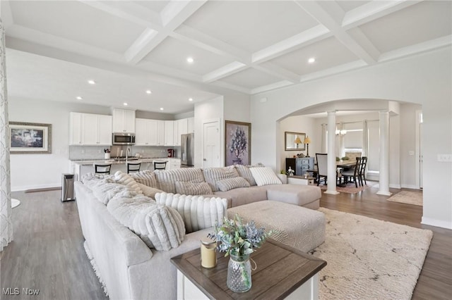 8488 Raya Ln, Streetsboro, OH 44241 - living area with decorative columns, arched walkways, wood finished floors, beamed ceiling, and coffered ceiling