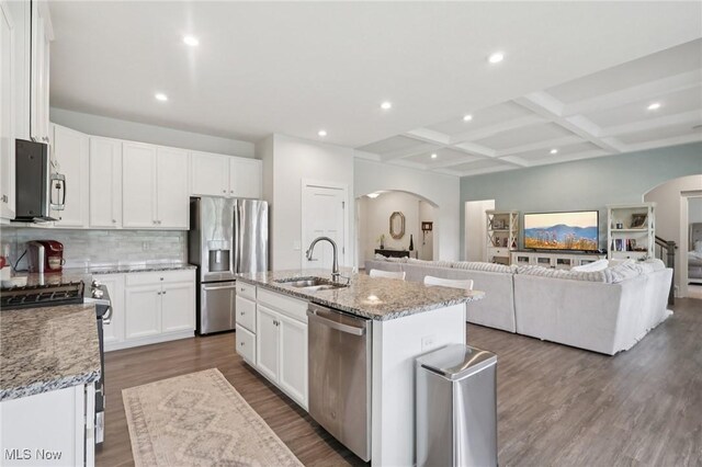 8488 Raya Ln, Streetsboro, OH 44241 - kitchen featuring appliances with stainless steel finishes, arched walkways, open floor plan, coffered ceiling, and beam ceiling
