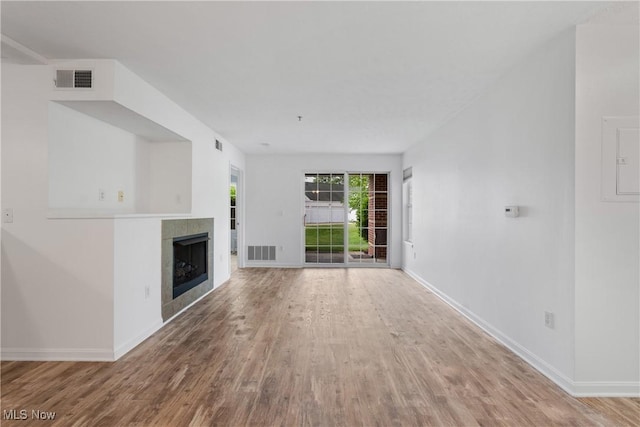23004 Chandlers Ln Unit 107, Olmsted Falls, OH 44138 - unfurnished living room featuring wood finished floors, a fireplace, and electric panel