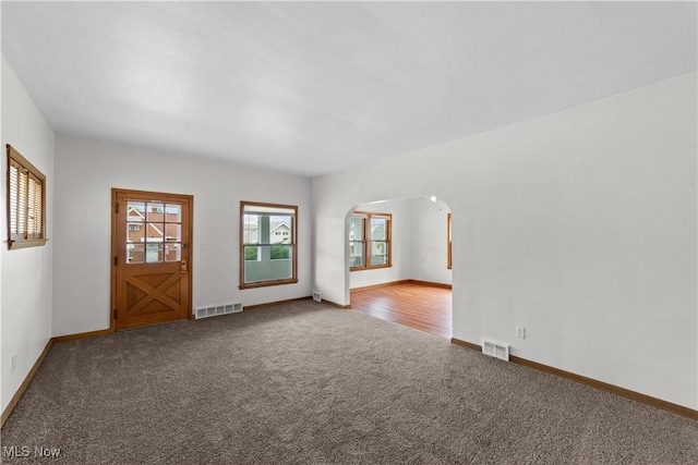 10808 Park Heights Ave, Garfield Heights, OH 44125 - carpeted spare room with arched walkways and plenty of natural light